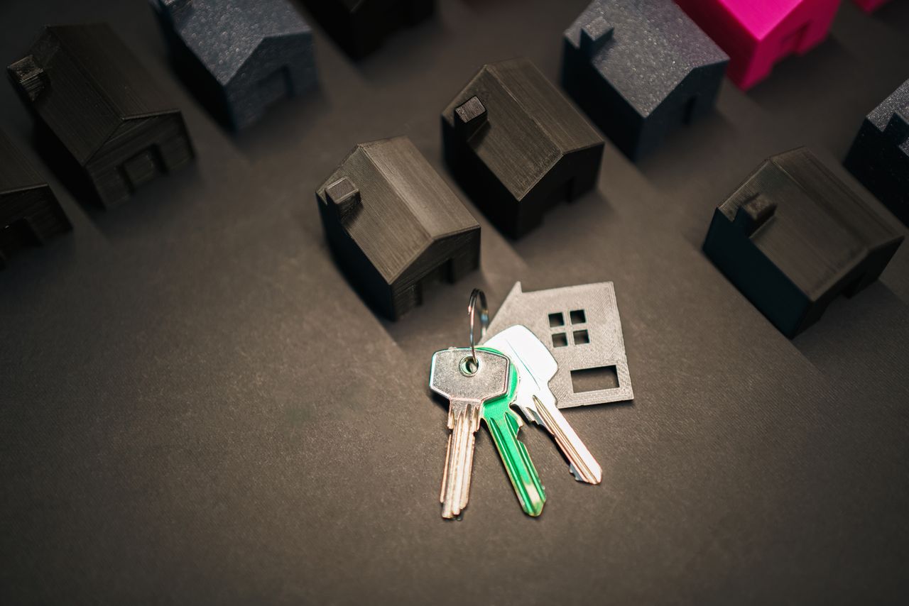 Home Miniature house models and keys symbolize real estate investment and housing market.